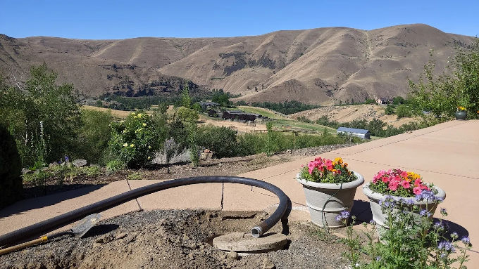 Septic pumping hose at a Kittitas County property, with the valley in the background