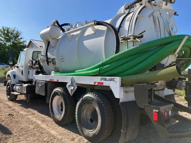 Dookie Septic vacuum truck with hose ready for a septic pumping job