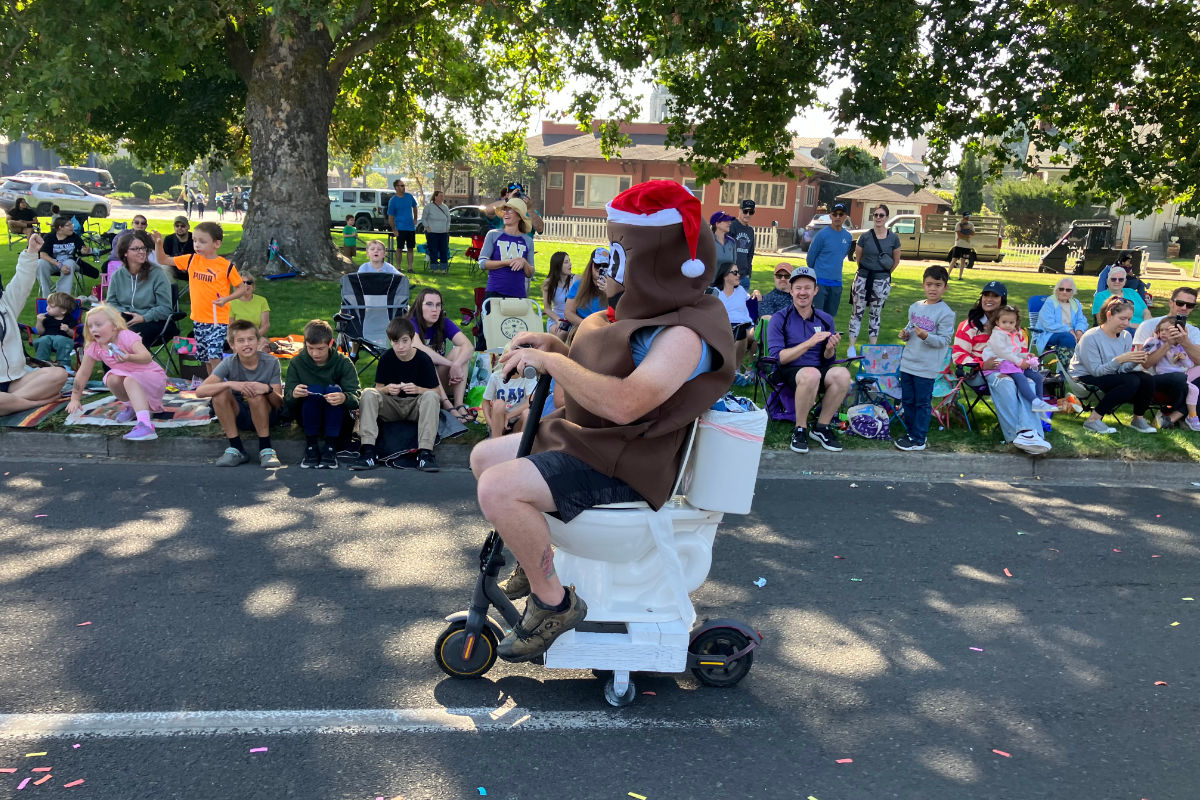 Dookie Septic's 'Rolling Dookie' toilet-scooter passing the crowd at the 2025 Yakima SunFair Parade